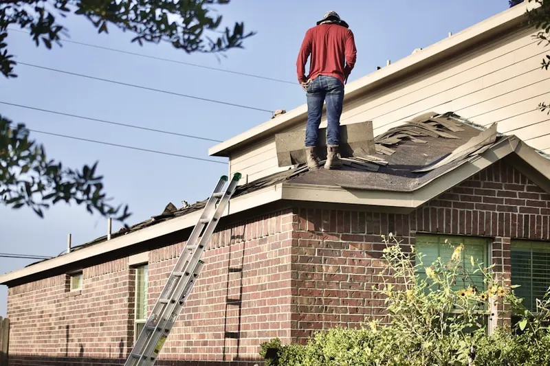 Professional roofer working on a residential roof in Grand Haven